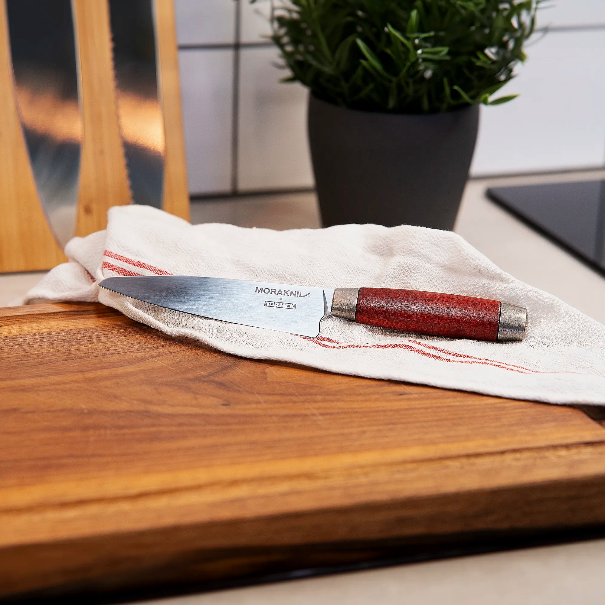 A Morakniv 1891 classic utility knife in a kitchen on a cutting board