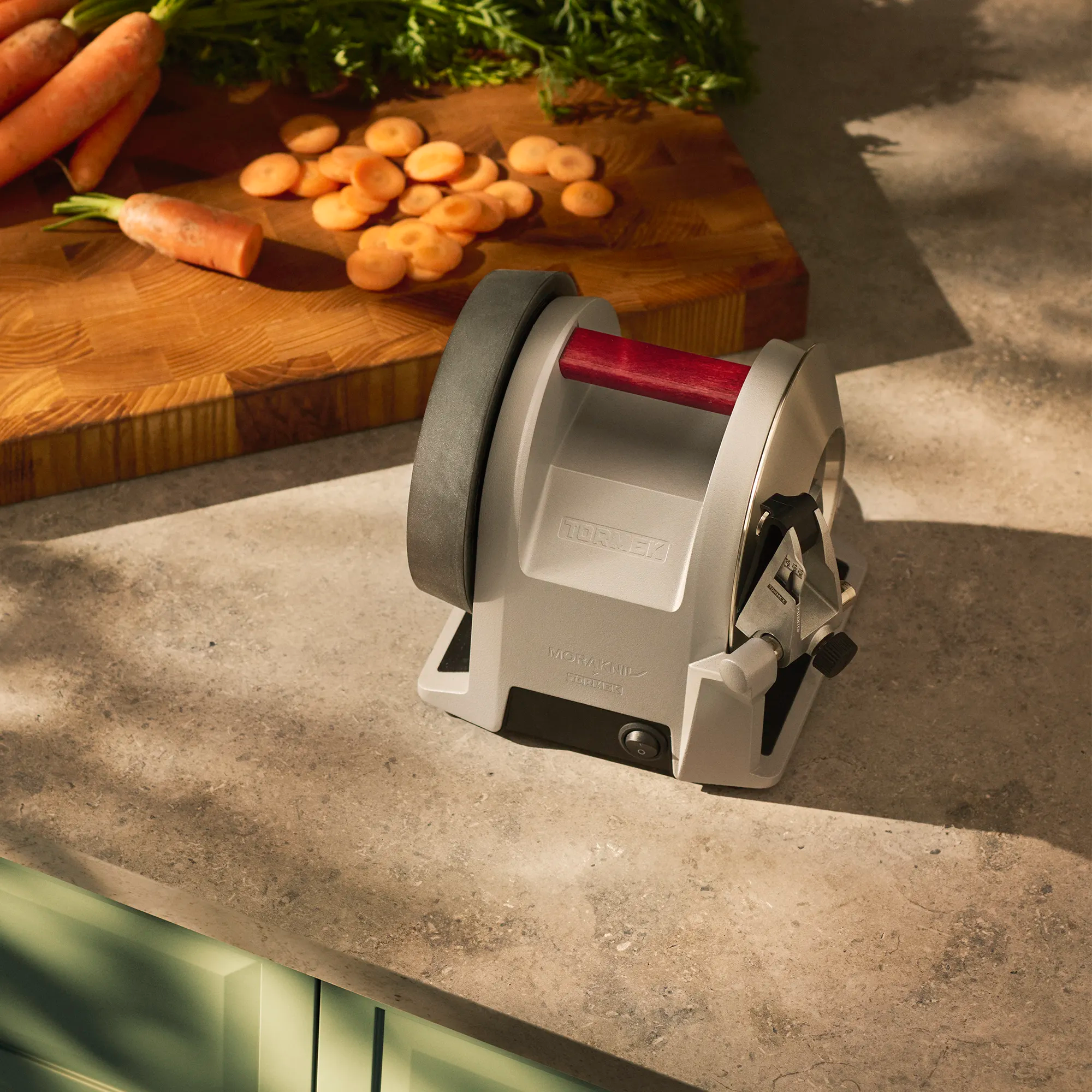 Tormek T-1 Morakniv 1891 in front of a cutting board with carrots. 